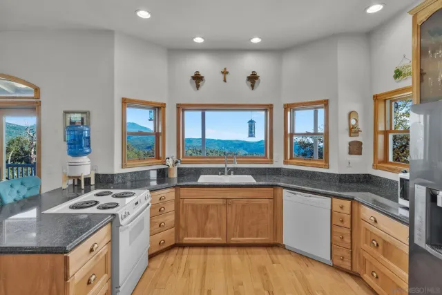 a kitchen with a sink stove and wooden cabinets