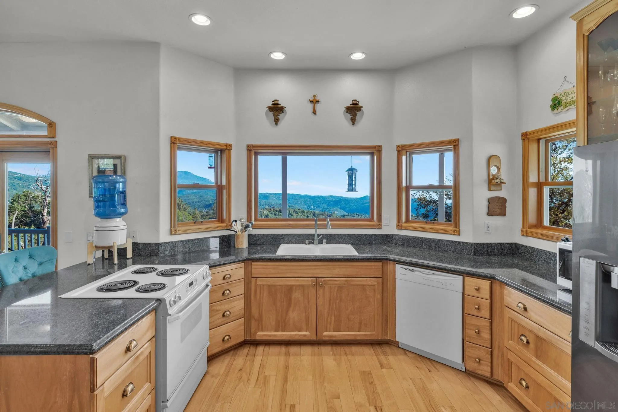 4819 Pine Ridge Avenue Julian, CA 92036 - Photo 11 of 51 a kitchen with a sink stove and wooden cabinets