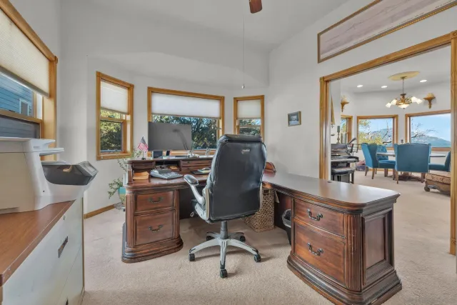 a view of a livingroom with workspace and a window
