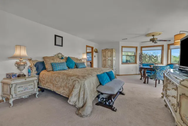 a bedroom with a bed and a chandelier