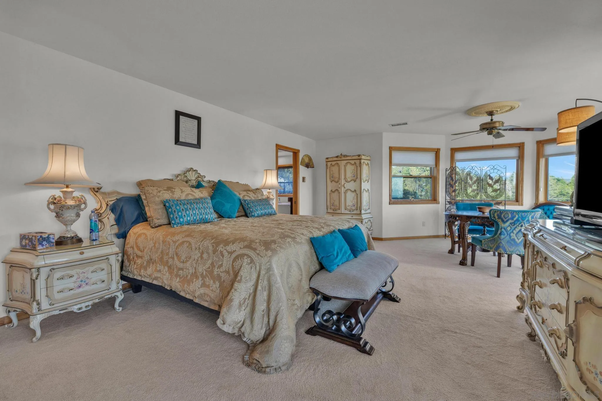 4819 Pine Ridge Avenue Julian, CA 92036 - Photo 28 of 51 a bedroom with a bed and a chandelier