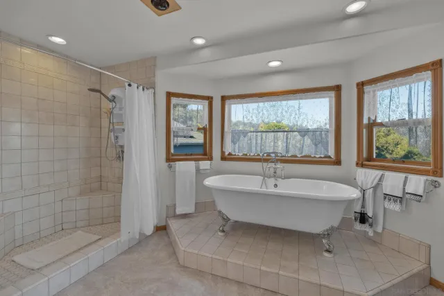 a spacious bathroom with a bathtub and shower