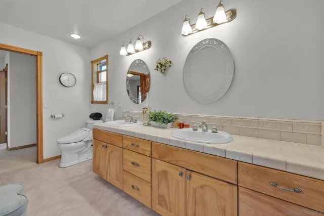 a bathroom with a double vanity sink and a mirror