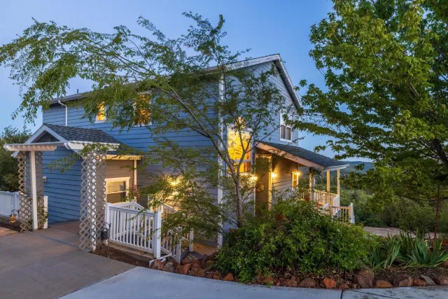 a yellow house with tree in front of it