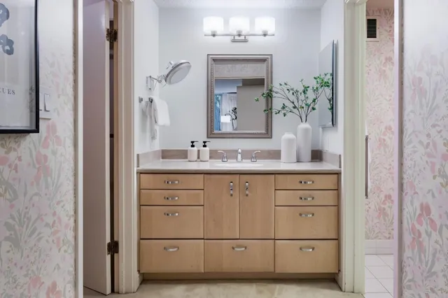 a bathroom with a granite countertop sink vanity granite and a mirror