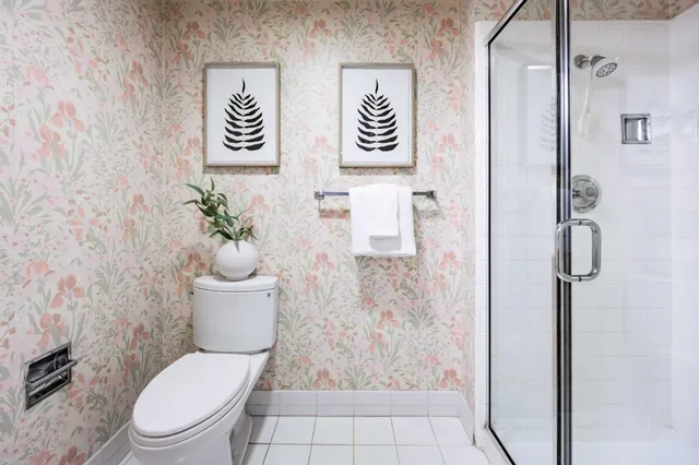 a white toilet sitting next to a bathroom sink