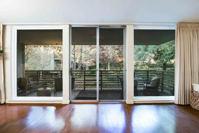 a view of outdoor space with wooden floor and a window
