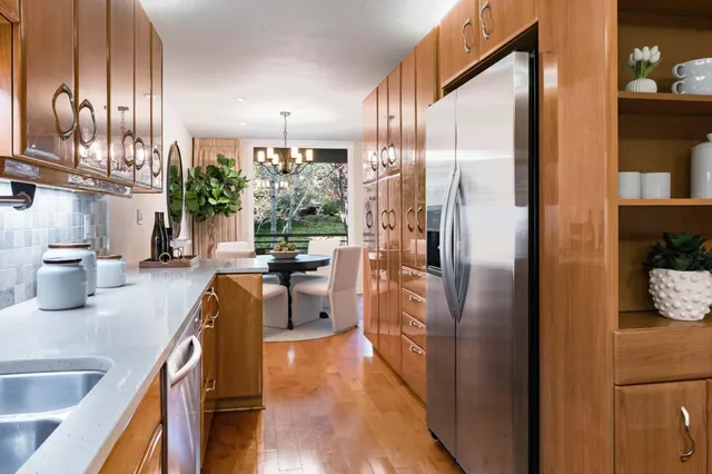 a kitchen with stainless steel appliances granite countertop a refrigerator and a sink