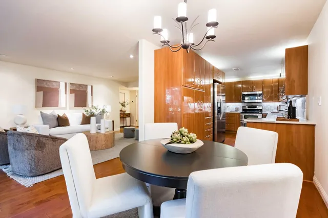 a view of a dining room with furniture wooden floor and chandelier