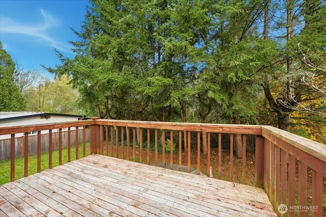a balcony with wooden floor and fence