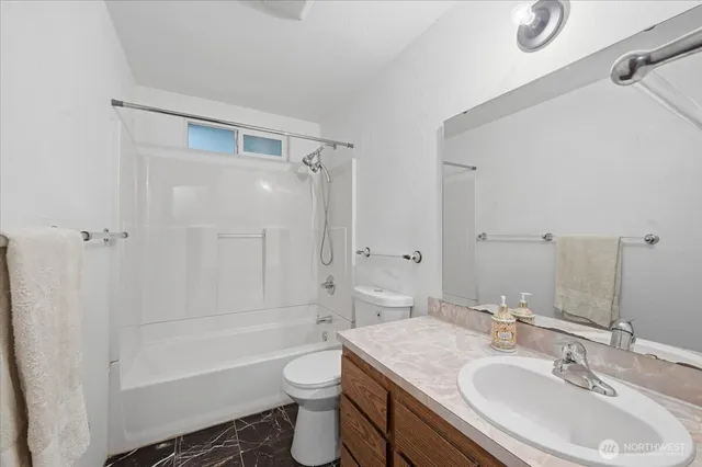 a bathroom with a sink toilet a shower and bathtub