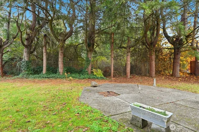 a backyard of a house with table and chairs