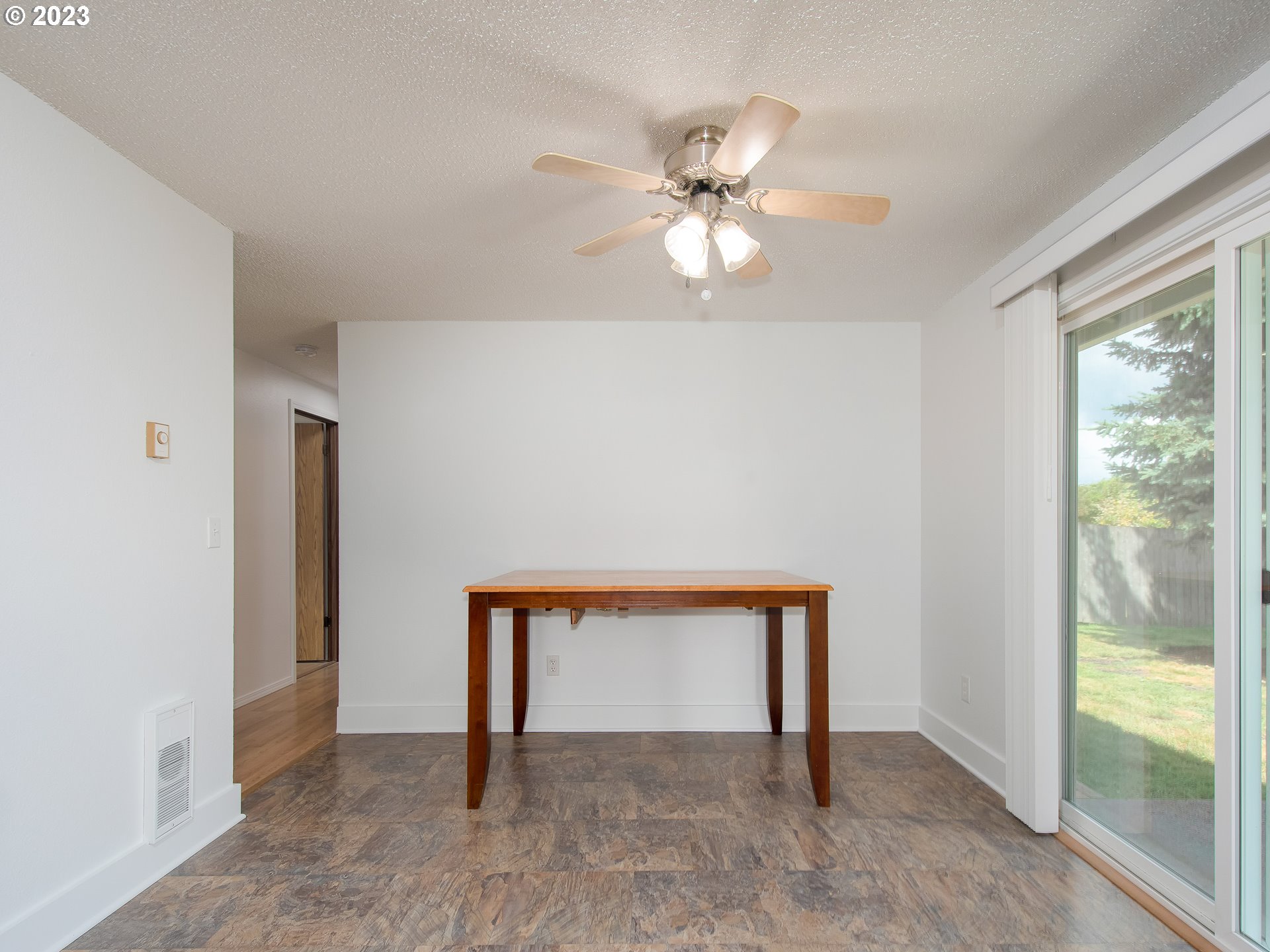 5208 Northeast 139th Loop Vancouver, WA 98682 - Photo 13 of 37 a view of an empty room with window and chandelier fan