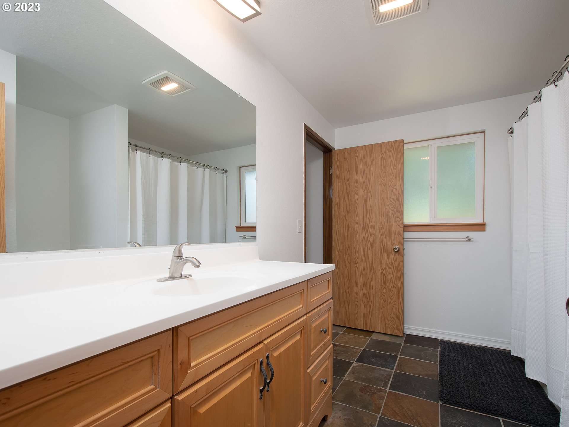 5208 Northeast 139th Loop Vancouver, WA 98682 - Photo 23 of 37 a bathroom with a sink a toilet and a mirror