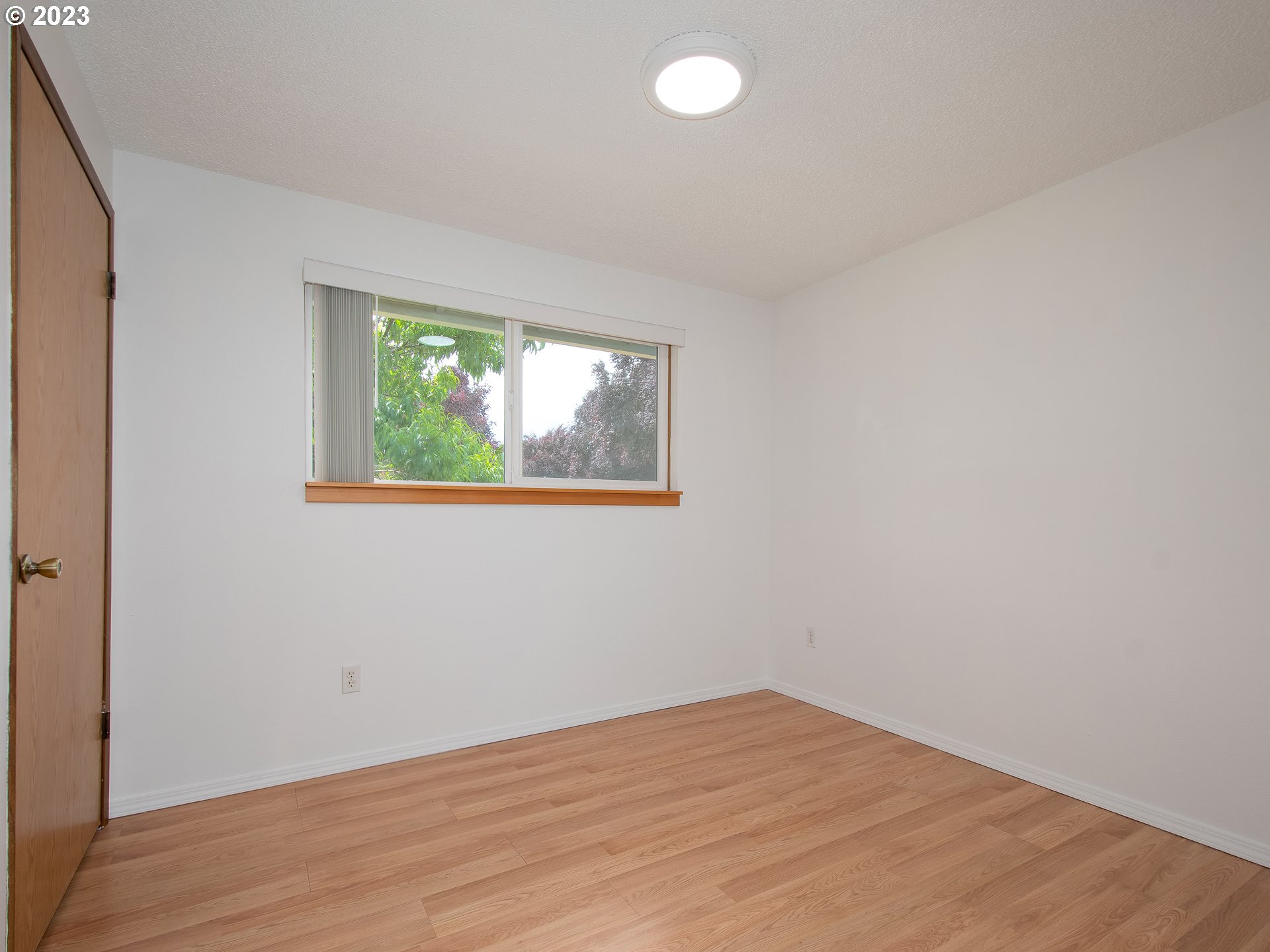 5208 Northeast 139th Loop Vancouver, WA 98682 - Photo 24 of 37 an empty room with wooden floor and windows