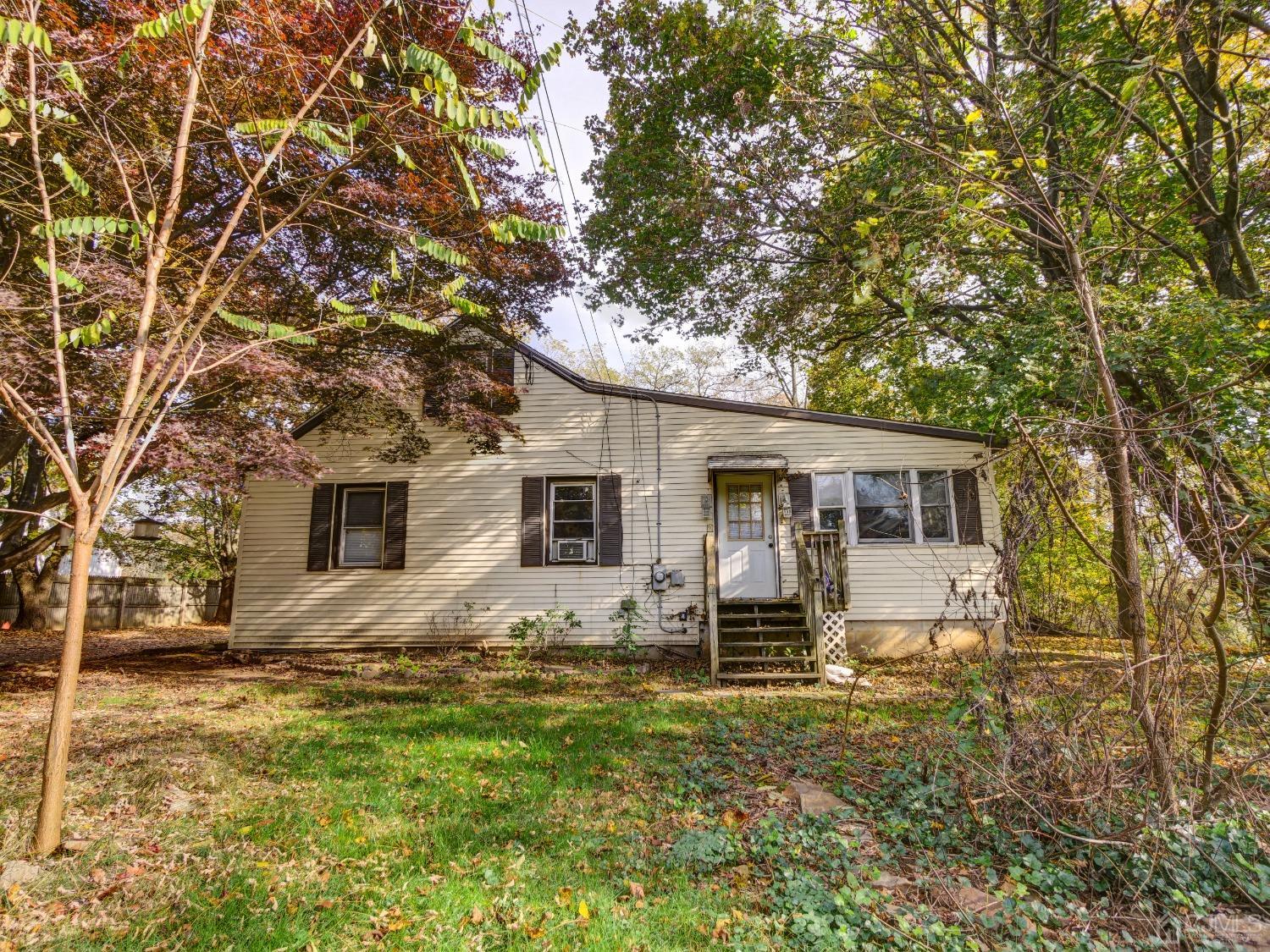 124 Half Acre Road Monroe Township, NJ 08831 - Photo 1 of 12 a house that has a tree in front of the house