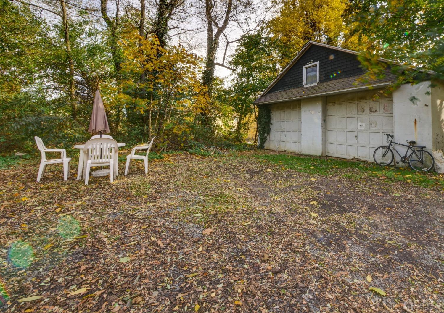124 Half Acre Road Monroe Township, NJ 08831 - Photo 12 of 12 a backyard of a house with table and chairs