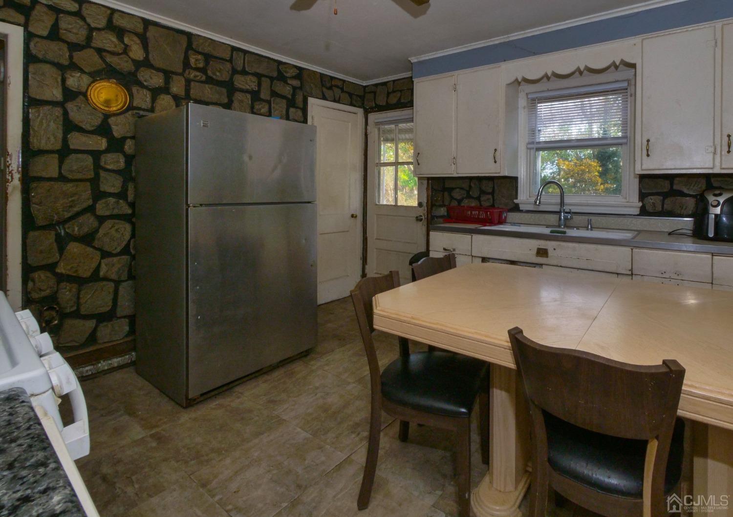 124 Half Acre Road Monroe Township, NJ 08831 - Photo 3 of 12 a kitchen with a table and chairs