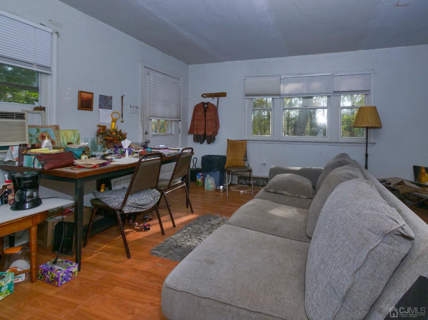 124 Half Acre Road Monroe Township, NJ 08831 - Photo 8 of 12 a living room with furniture and wooden floor