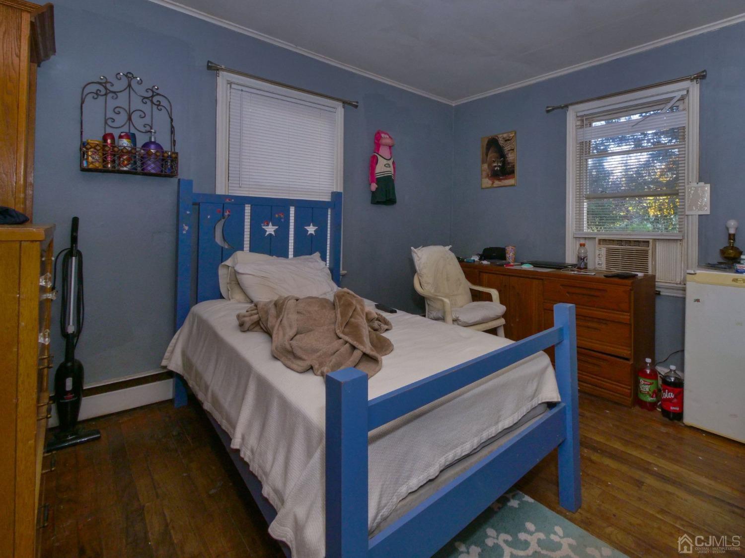 124 Half Acre Road Monroe Township, NJ 08831 - Photo 10 of 12 a bed sitting in a bedroom next to a window with a bookshelf