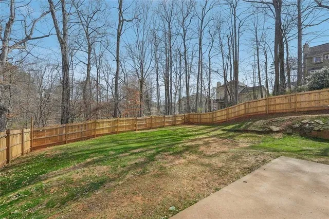 a big white house with a big yard and large trees
