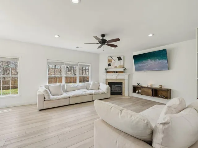 a living room with furniture fireplace and flat screen tv