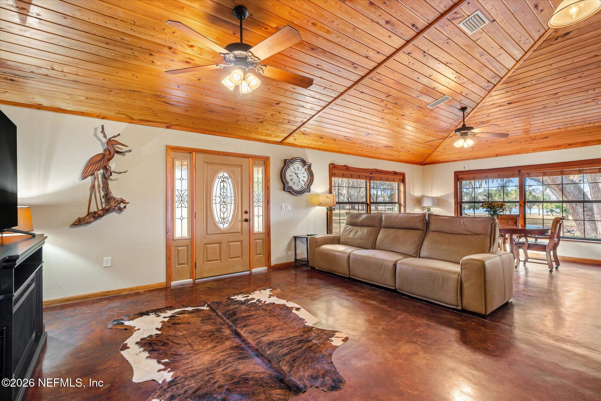 118 Hooks Lake Road Melrose, FL 32666 - Photo 12 of 61 a living room with furniture and a flat screen tv