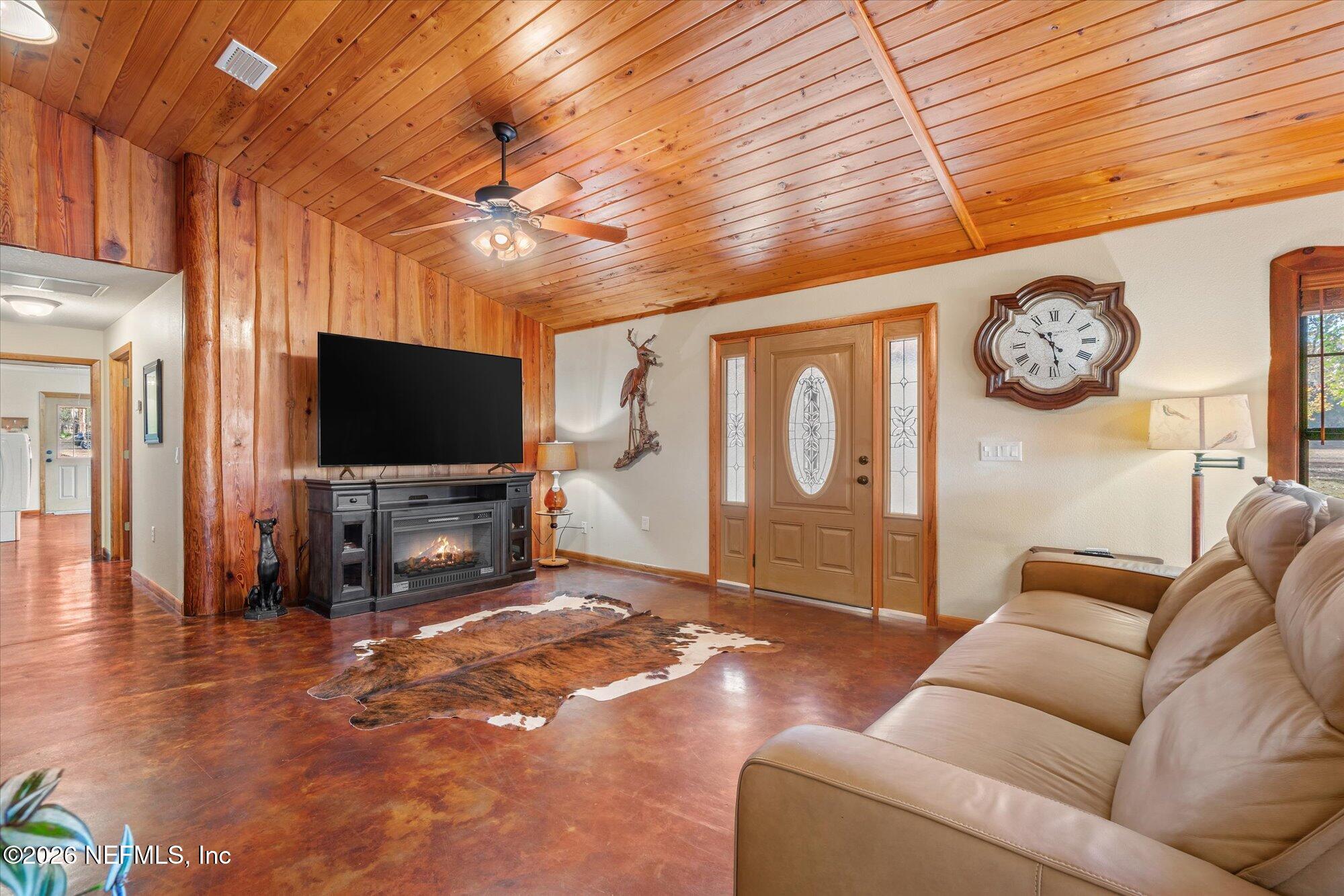 118 Hooks Lake Road Melrose, FL 32666 - Photo 13 of 61 a living room with furniture and a flat screen tv
