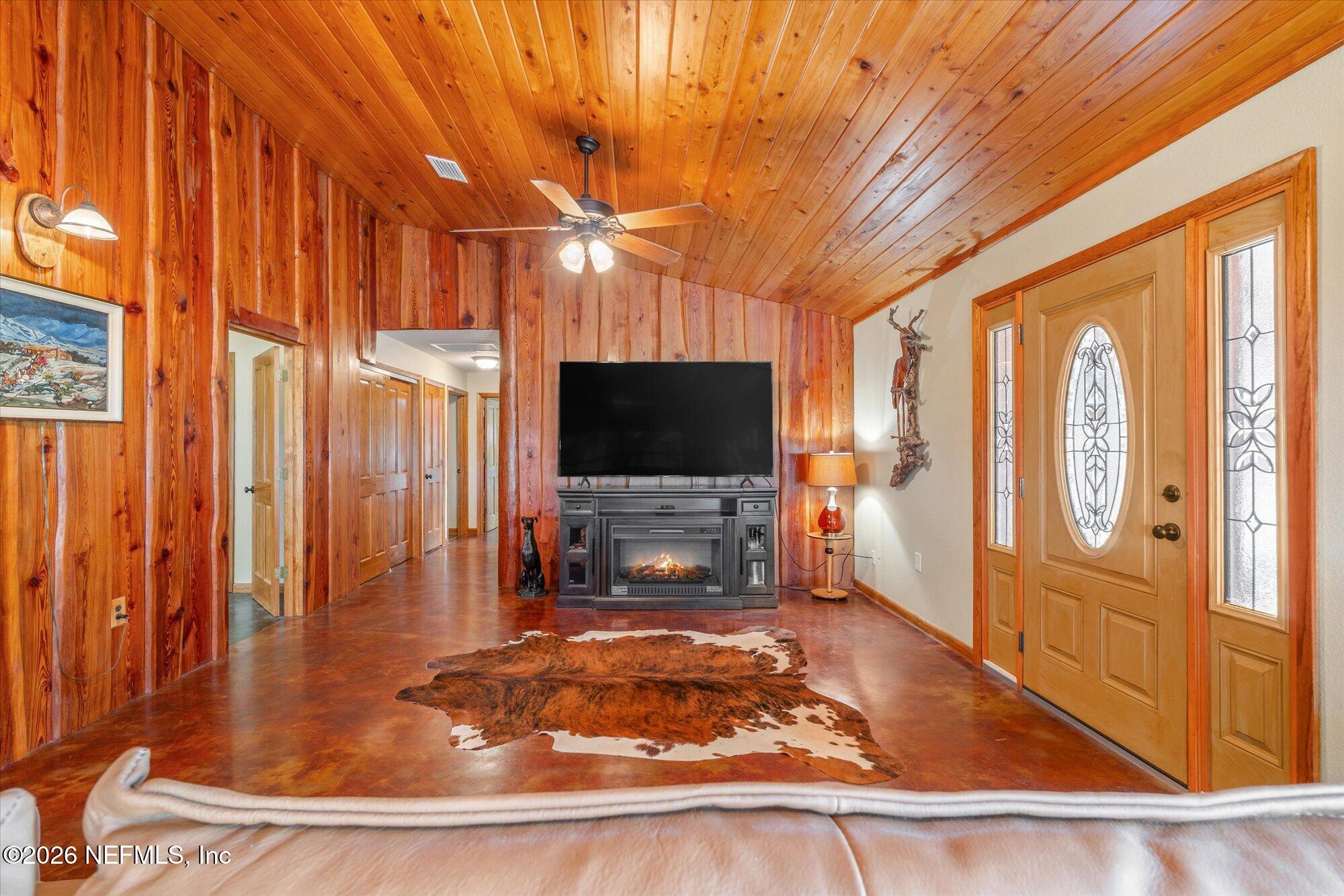 118 Hooks Lake Road Melrose, FL 32666 - Photo 14 of 61 a living room with a large window and a flat screen tv