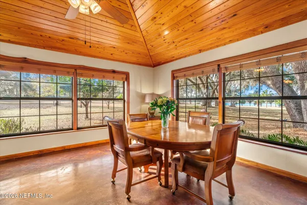 a dining room with furniture and a flat screen tv