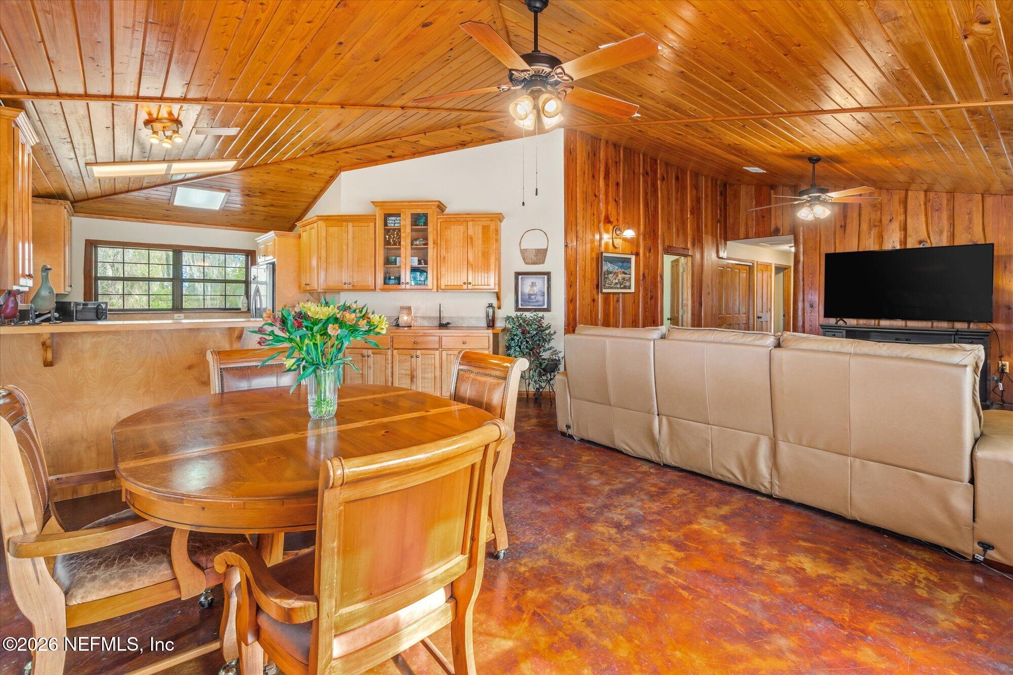 118 Hooks Lake Road Melrose, FL 32666 - Photo 22 of 61 a dining room with furniture and a flat screen tv