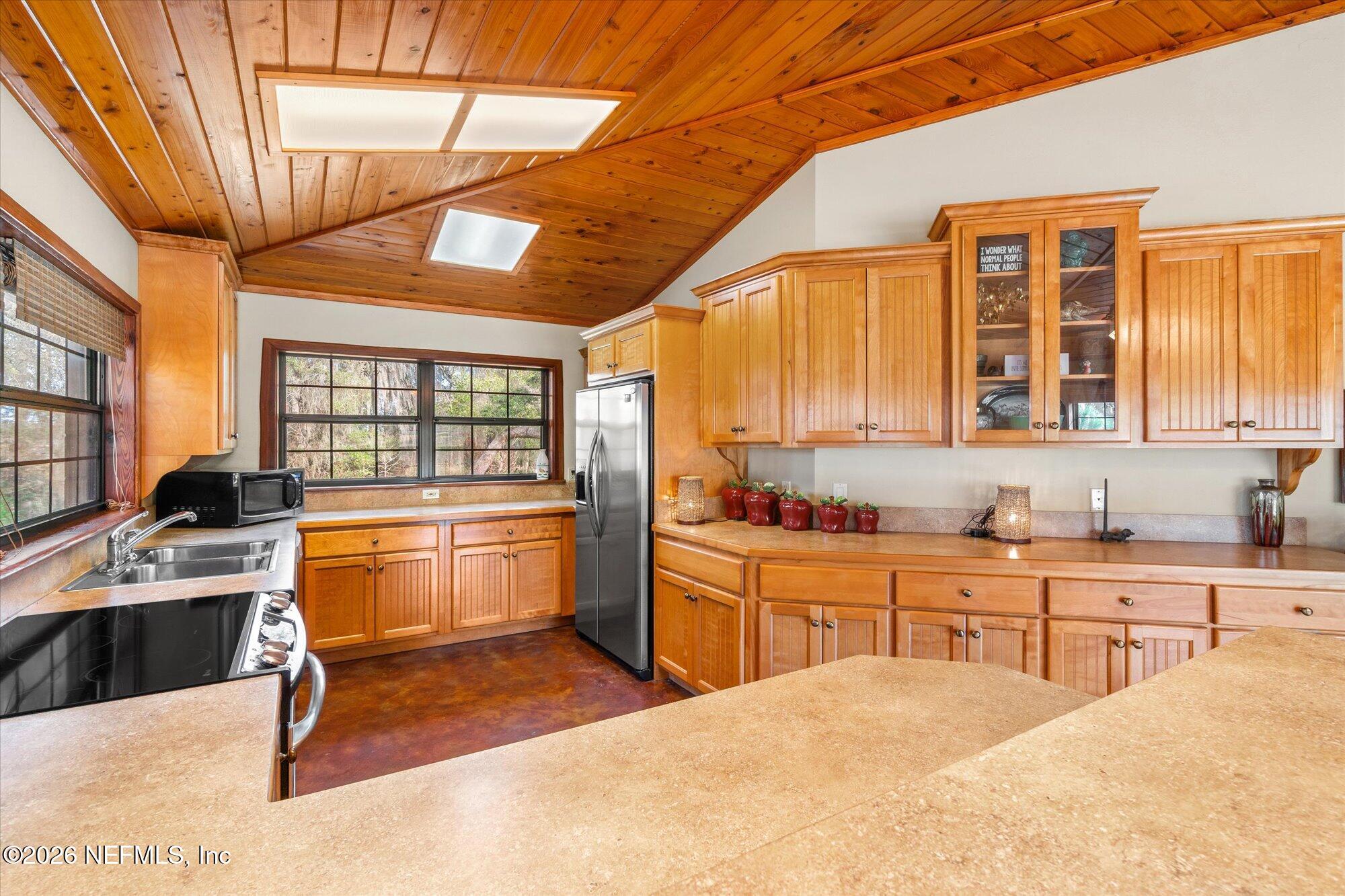 118 Hooks Lake Road Melrose, FL 32666 - Photo 23 of 61 a large kitchen with stainless steel appliances kitchen island granite countertop a sink and cabinets