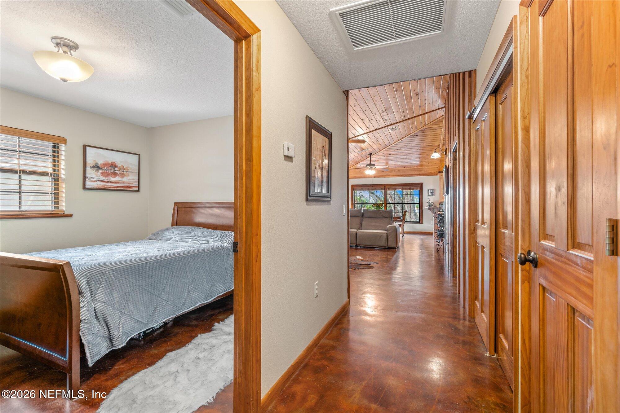 118 Hooks Lake Road Melrose, FL 32666 - Photo 29 of 61 a bedroom with a bed and wooden floor