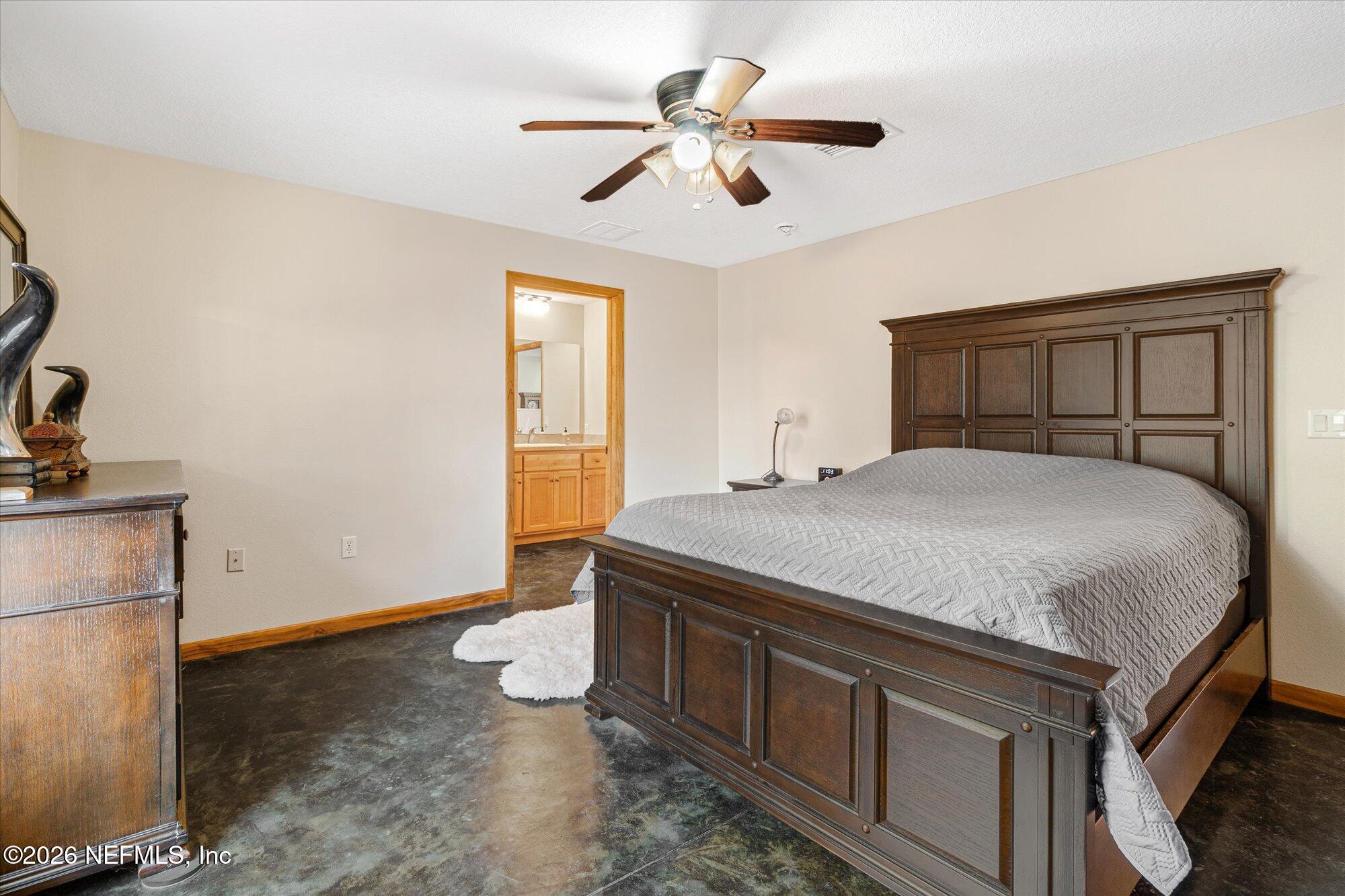 118 Hooks Lake Road Melrose, FL 32666 - Photo 32 of 61 a bedroom with a bed and a chandelier