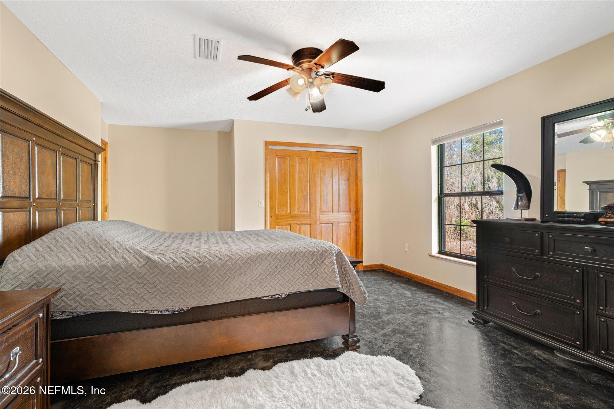 118 Hooks Lake Road Melrose, FL 32666 - Photo 33 of 61 a bedroom with a bed and a dresser with mirror