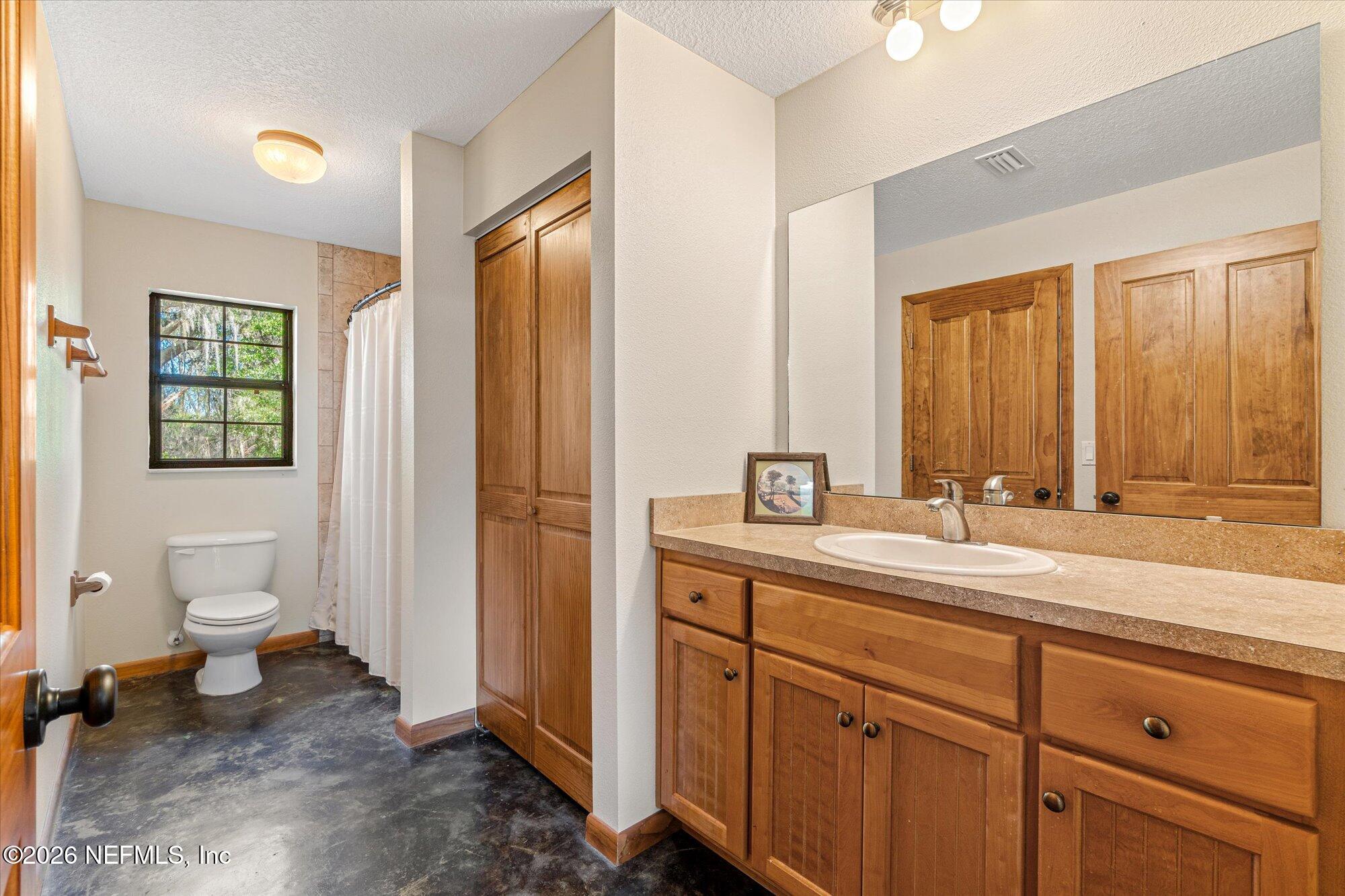 118 Hooks Lake Road Melrose, FL 32666 - Photo 34 of 61 a spacious bathroom with a toilet sink and mirror