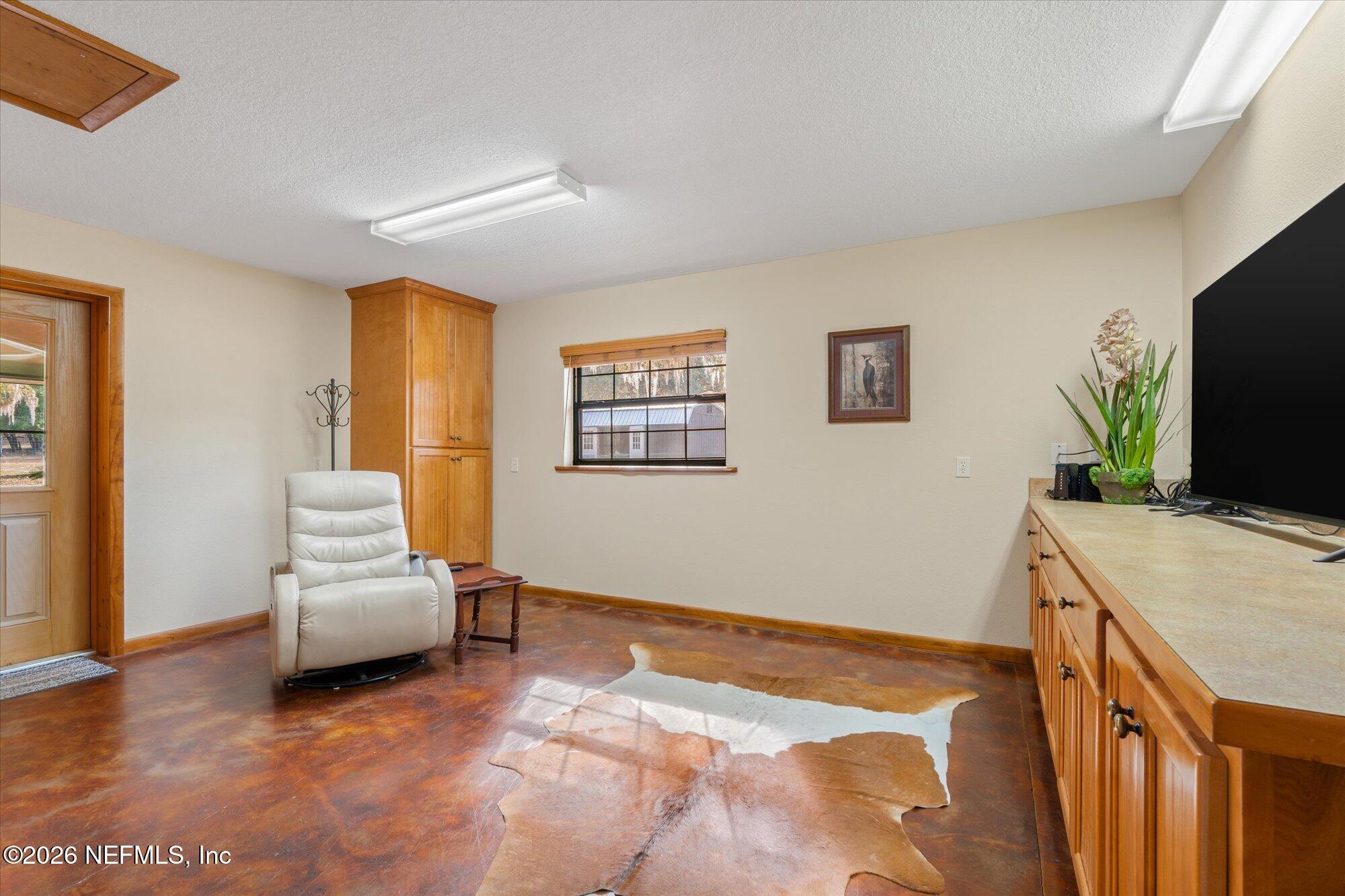 118 Hooks Lake Road Melrose, FL 32666 - Photo 37 of 61 a bedroom with a bed and a flat screen tv