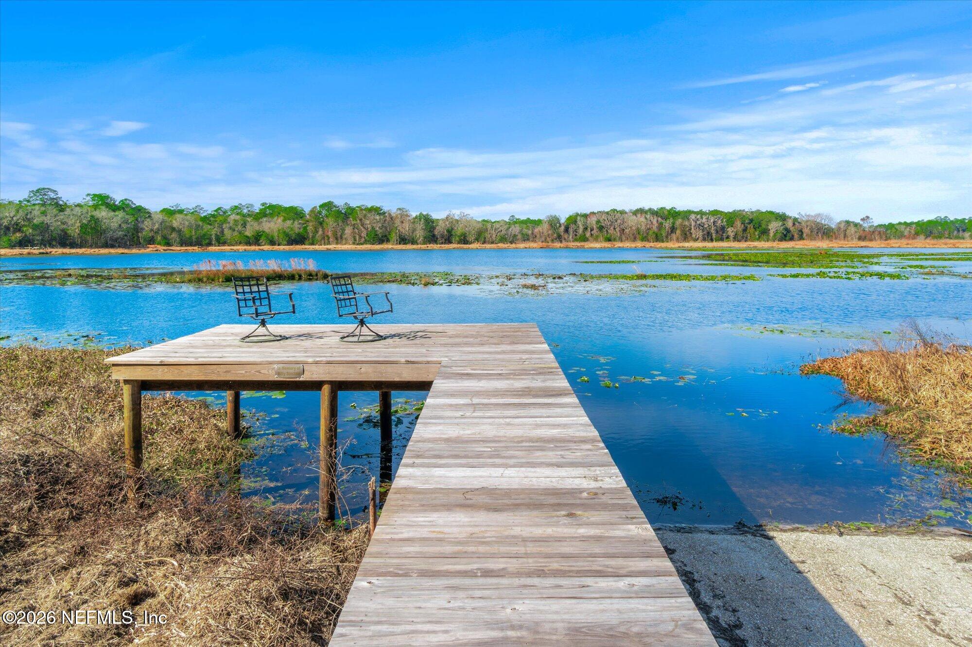 118 Hooks Lake Road Melrose, FL 32666 - Photo 43 of 61 a view of a lake with a table and chairs