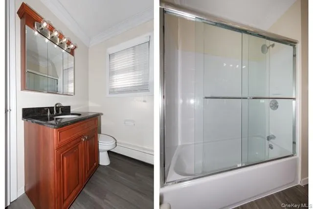 a bathroom with a granite countertop sink mirror vanity and toilet
