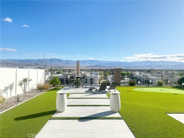 a view of a swimming pool and an outdoor seating