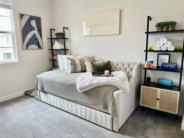 a bedroom with a bed and a painting on the wall