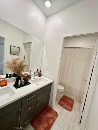 a bathroom with a double vanity sink and a mirror
