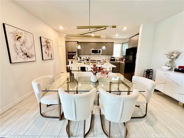 a view of a dining room with furniture wooden floor and chandelier