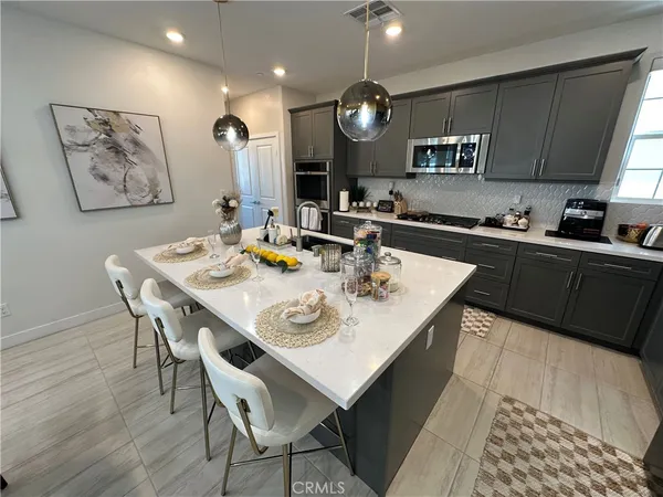 a kitchen with a dining table and chairs