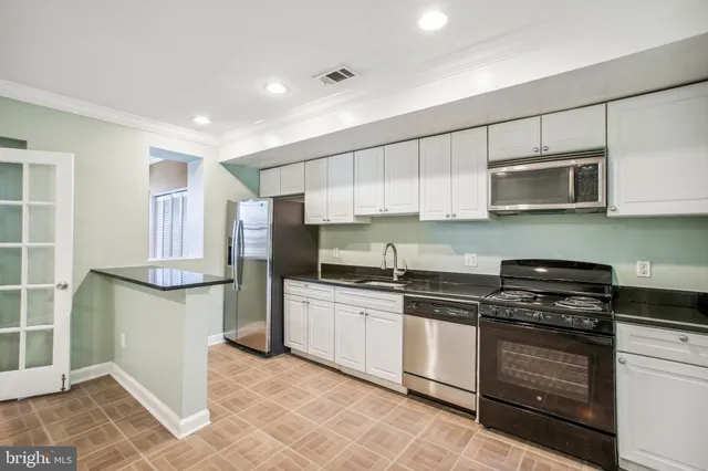 a kitchen with stainless steel appliances granite countertop a stove and a refrigerator