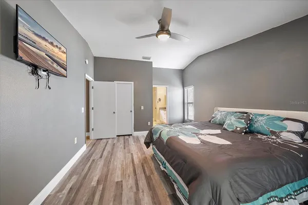 a bedroom with a large bed and a chandelier