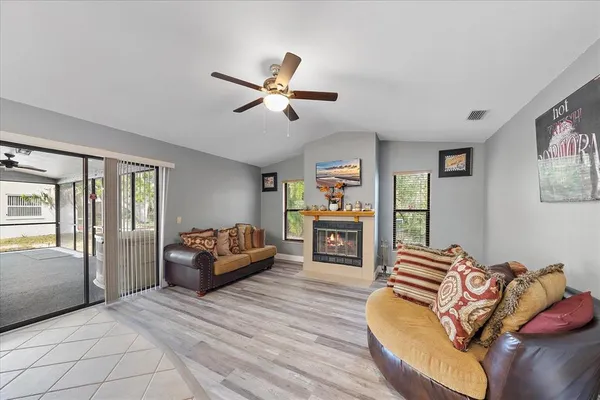 a spacious bedroom with a bed a couch and a chandelier