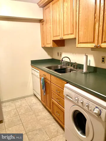 a kitchen with stainless steel appliances granite countertop a sink a stove and cabinets