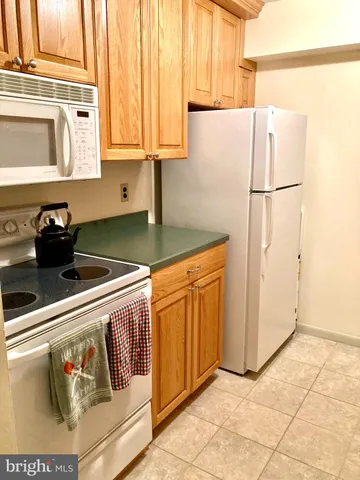 a kitchen with stainless steel appliances granite countertop a refrigerator sink and cabinets