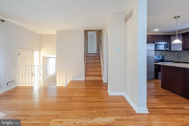 a view of a kitchen with wooden floor and a kitchen